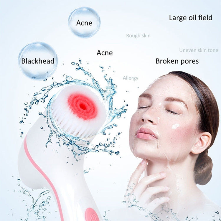 Pink facial cleansing device with red silicone brush head beside skincare foam