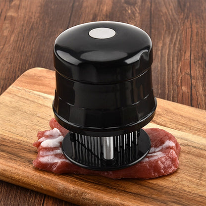 Stainless steel 56-pin meat tenderizer tool with black handle on steak