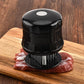 Black stainless 56-pin meat tenderizer with pin drum resting on steak