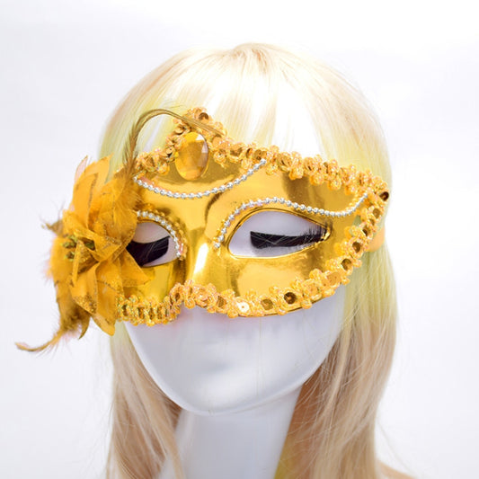 Gold Venetian masquerade mask with rhinestone trim, jeweled eye panels, and yellow feather flower