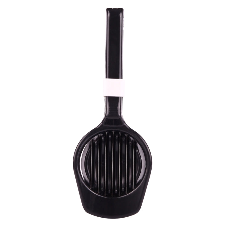 Black and white egg slicer utensil with vertical slicing ridges