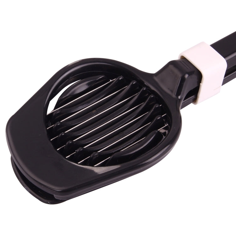 Black egg slicer with white handle accent and round slicing base