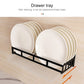 Wall-mounted drawer-style rack with black frame holding white plates