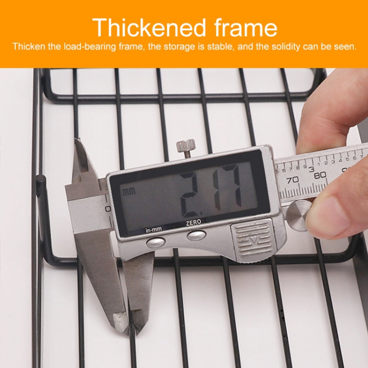 Black wire seasoning rack with thick frame, measured close-up with caliper