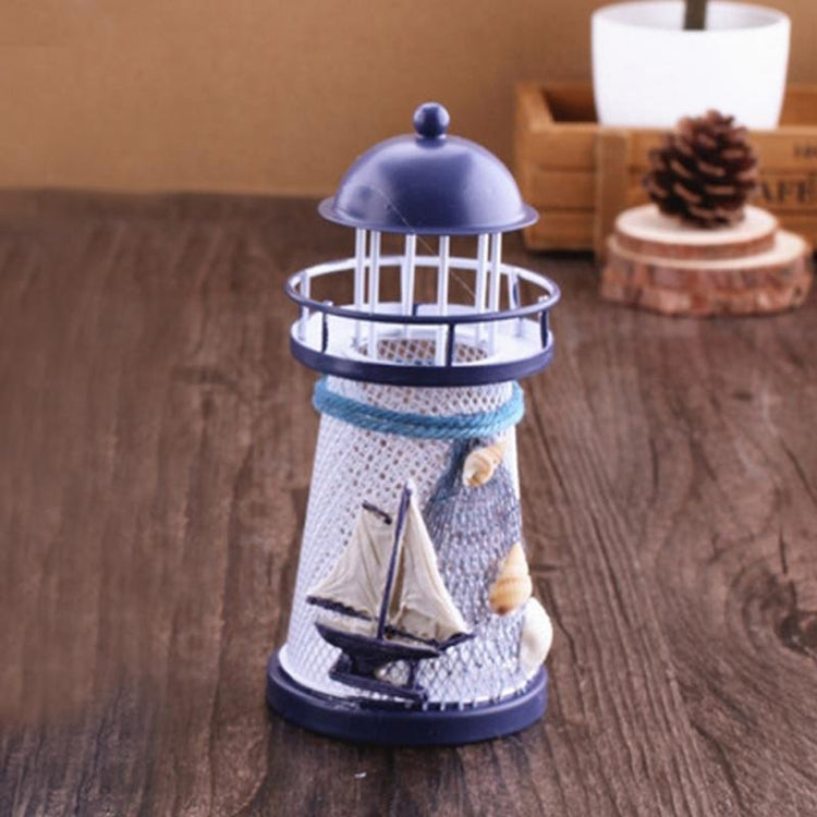 Handmade metal lighthouse ornament with blue dome and wire lantern cage, sail front