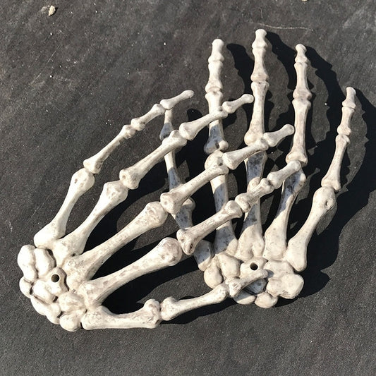 Pair of white skeleton hand decorations with visible bones and fingers
