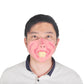 Adult wearing pink clown latex half-face mask with open mouth and a single yellow tooth