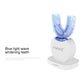 White electric silicone toothbrush on stand with blue-light whitening bristle head