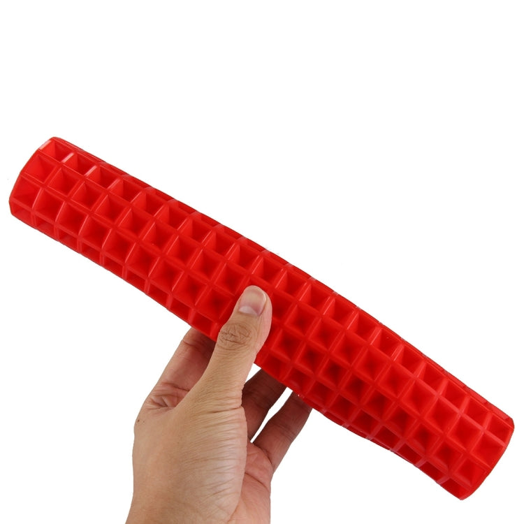 Red silicone food pad, diamond-grid texture, shown held by hand