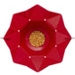 Red foldable silicone popcorn maker open with unpopped corn kernels in center