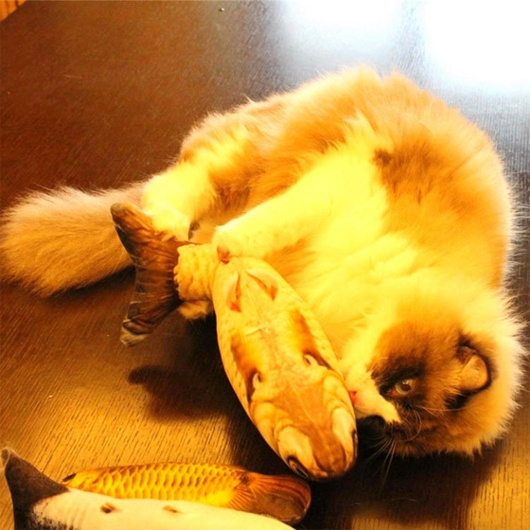 Cat pawing a fish-shaped plush scratching toy in yellow with orange stripes