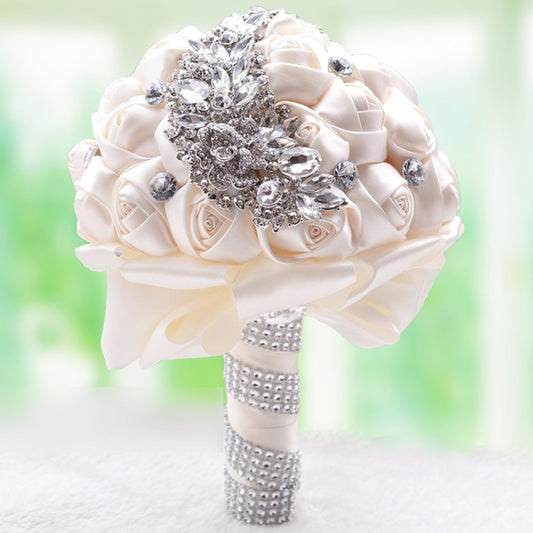White satin rose bridal bouquet with rhinestone brooch and jeweled wrapped handle