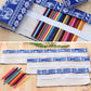 Open blue elephant print canvas pencil case showing 48 slots and colored pencils