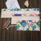 Flat roll-up pencil case with starry galaxy fabric, elastic holders and drawstring flap