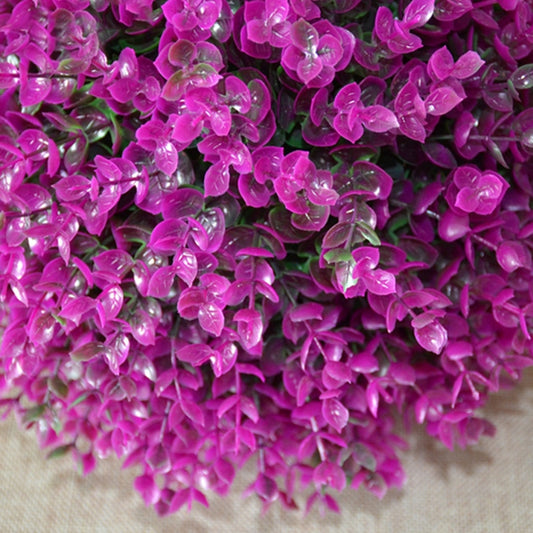 Close-up of artificial purple eucalyptus ball topiary, dense textured foliage
