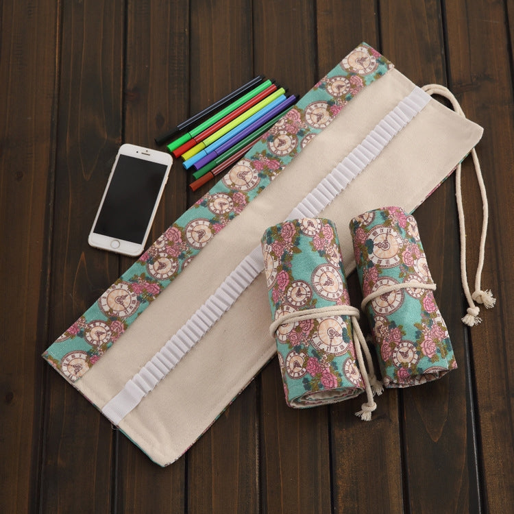 Cream canvas pencil roll with teal rose-clock fabric, white elastic bands, drawstring closure