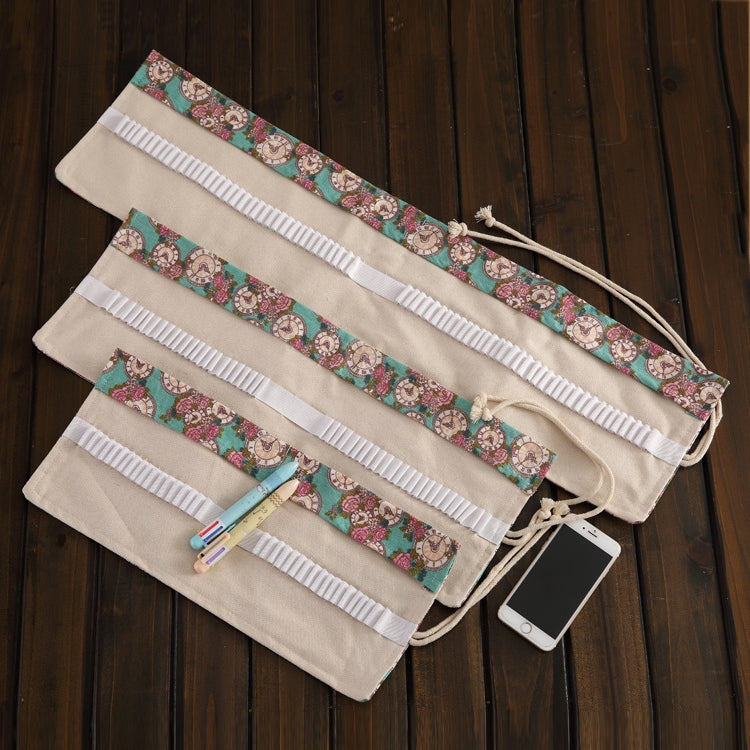 Unrolled cream pencil wrap with rose-and-clock print, multiple elastic pocket rows and ties