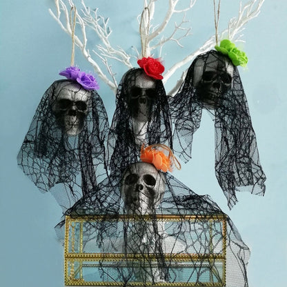 Black tulle hanging skull ornaments with flower accents, set on gold window display