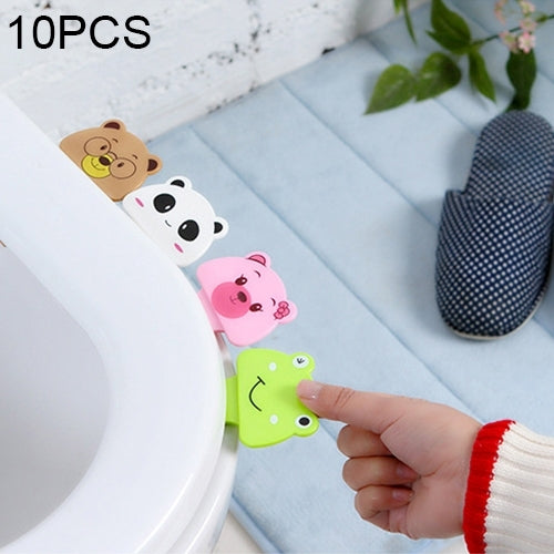 10-pack cartoon toilet lid covers with animal faces; hand places a small green piece