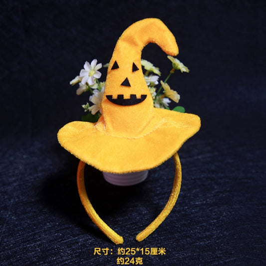 Yellow plush jack-o-lantern witch headband with flower accents and smiling pumpkin face