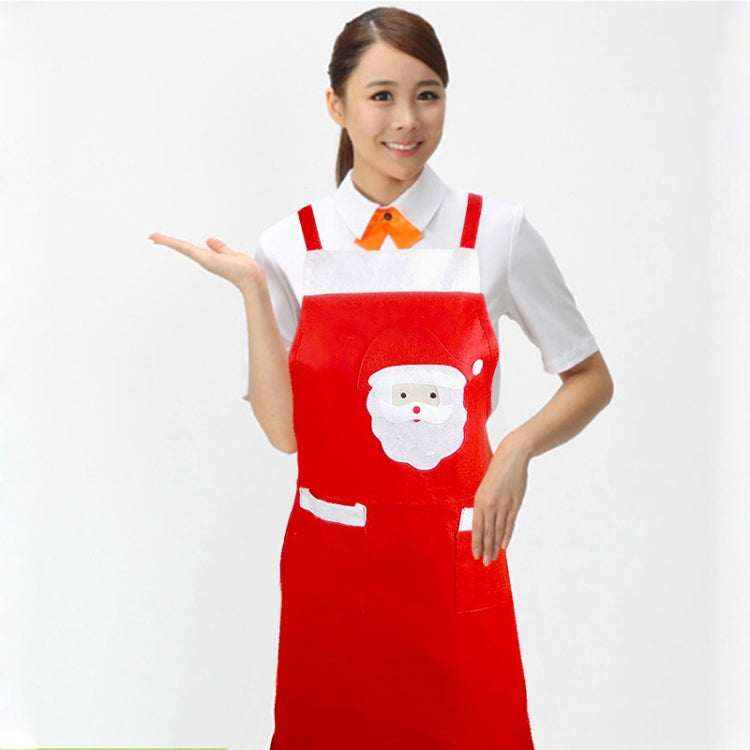 Red Santa apron worn over a white shirt, featuring a Santa face pocket and white hem