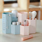 Pink hexagon stationery organizer with makeup brushes and bottles