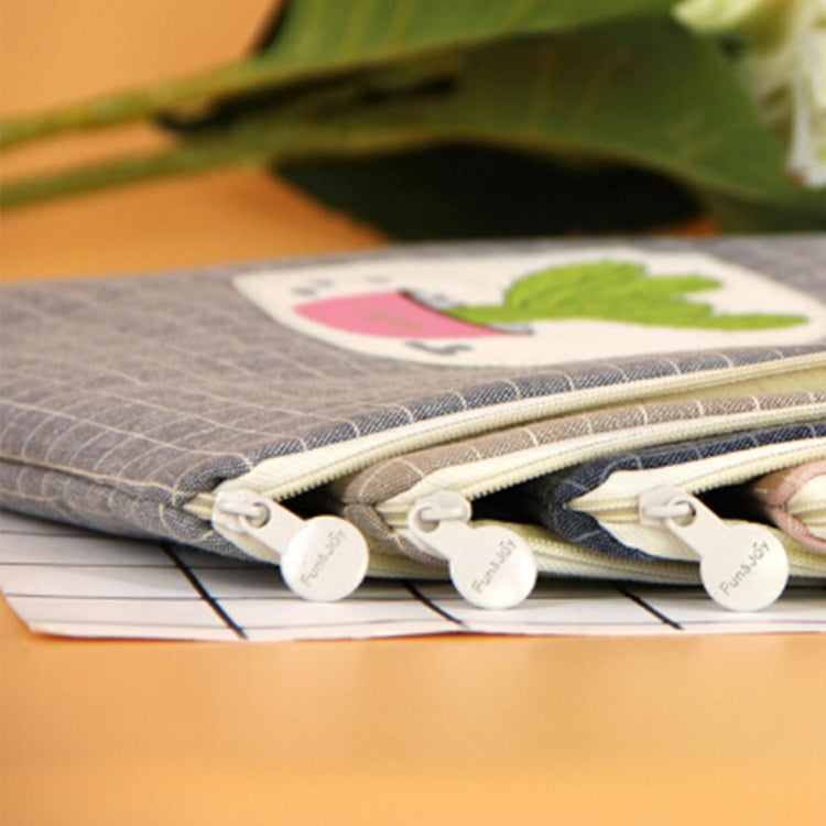 Close-up of zip pocket on gray canvas file bag with cactus applique.
