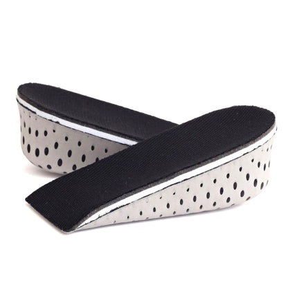 Black-and-white heel insert pad with curved arch support and dotted underside