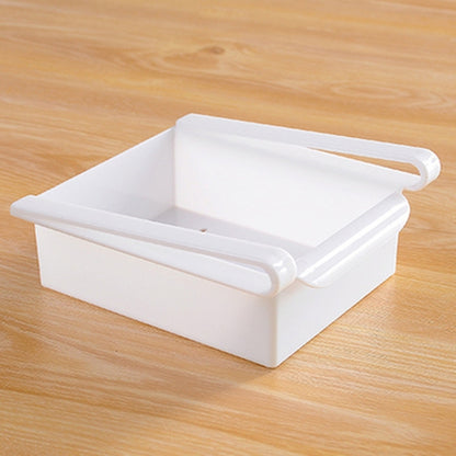 White plastic drawer-style fridge storage rack with open tray and side pull handles