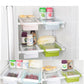 White drawer-style fridge storage rack with handle bars inside a refrigerator compartment
