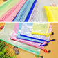Assorted zipper mesh stationery pouches laid out with colorful zipper tabs