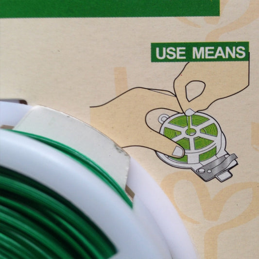Green twist tie line reel with metal cutter tool, shown with usage diagram