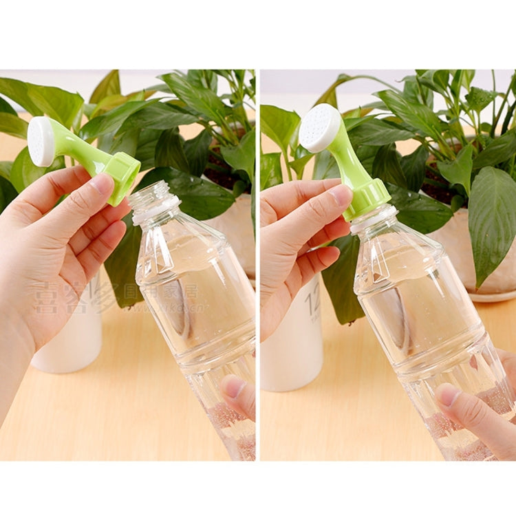 Handheld spray nozzle attaching to a clear bottle for watering potted plants