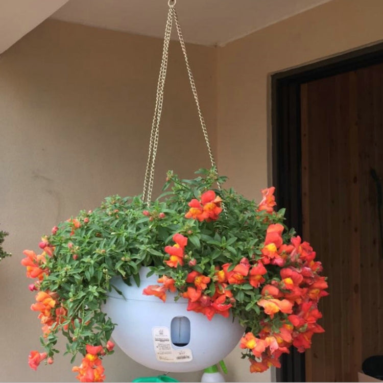Large hanging plastic flower pot with chain, white with orange and red artificial flowers