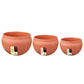 Three orange round plastic flower pots in different sizes, each with side drainage cutout