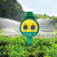 Green digital water timer with LCD dial during garden watering spray
