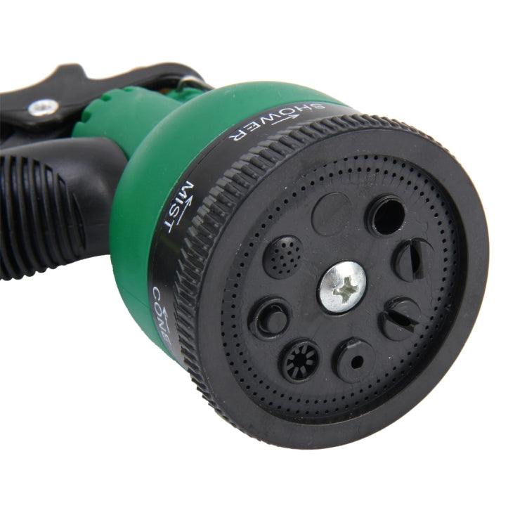Close-up of green garden spray nozzle head with patterned spray settings and dial