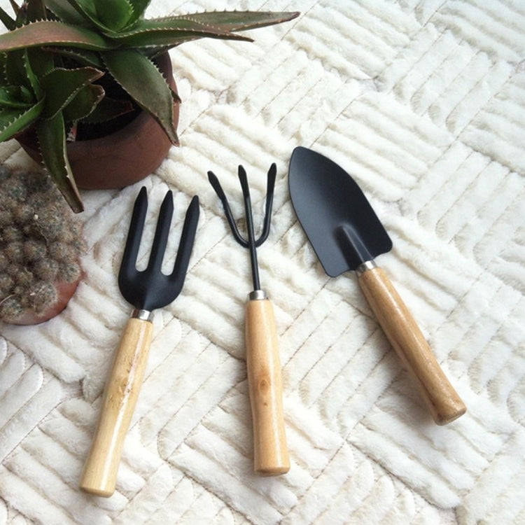Mini garden tool set with three wooden-handled heads: fork, spade, and rake