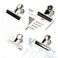 Chrome-silver round binder clips holding office document corners