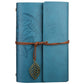 Blue leather-look travel diary notebook with embossed leaf pattern, wrap strap, and leaf charm