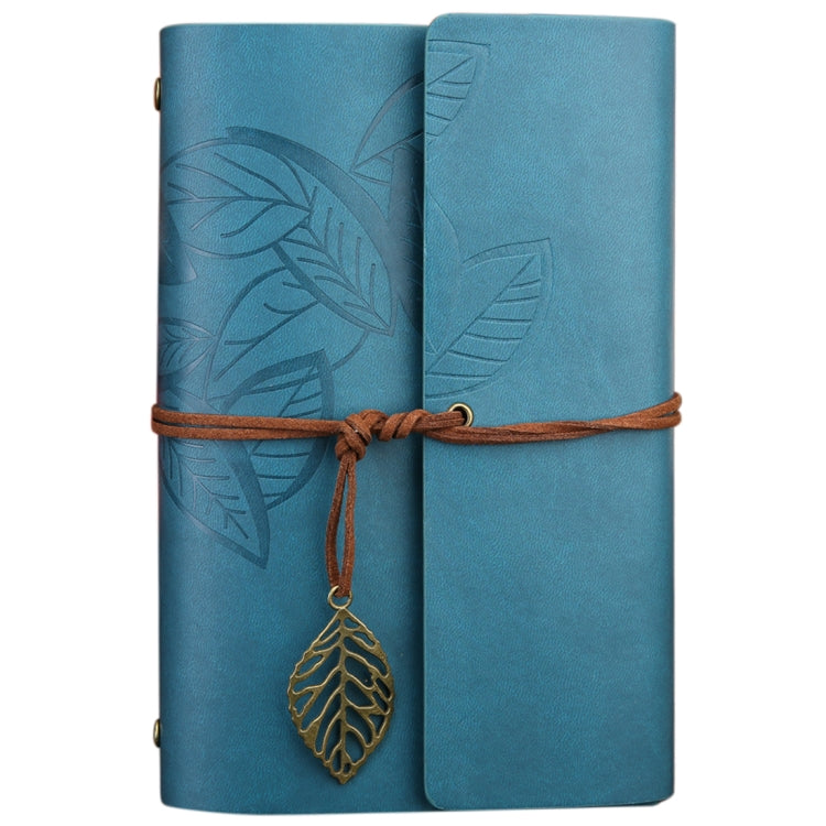 Blue loose-leaf travel diary notebook with embossed leaf pattern, leather strap, charm tag