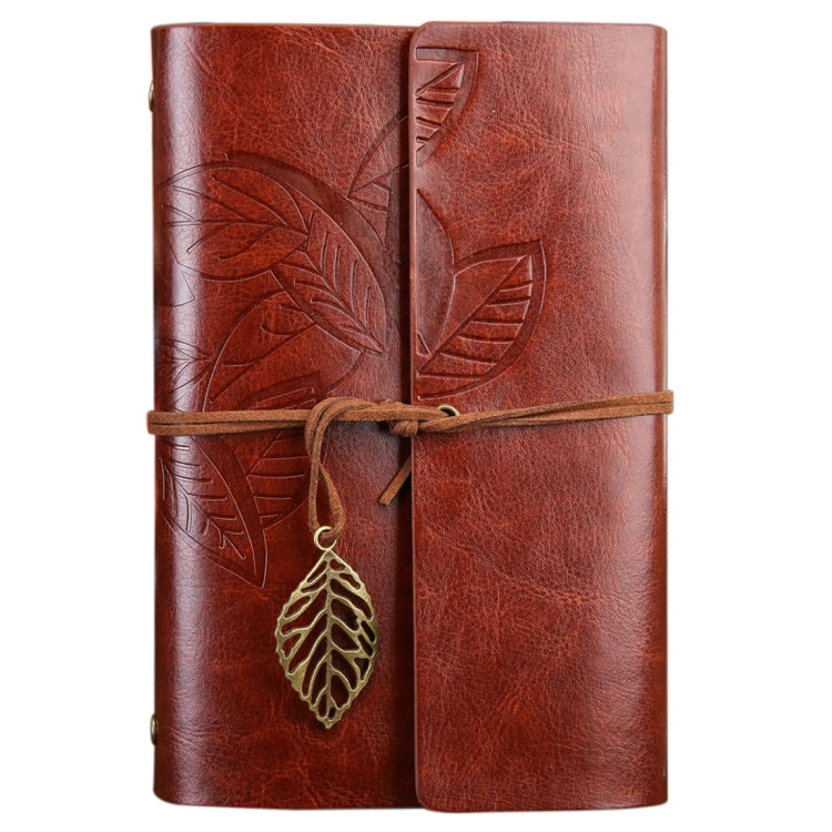 Brown loose-leaf travel diary notebook with embossed leaf cover, leather strap and leaf charm