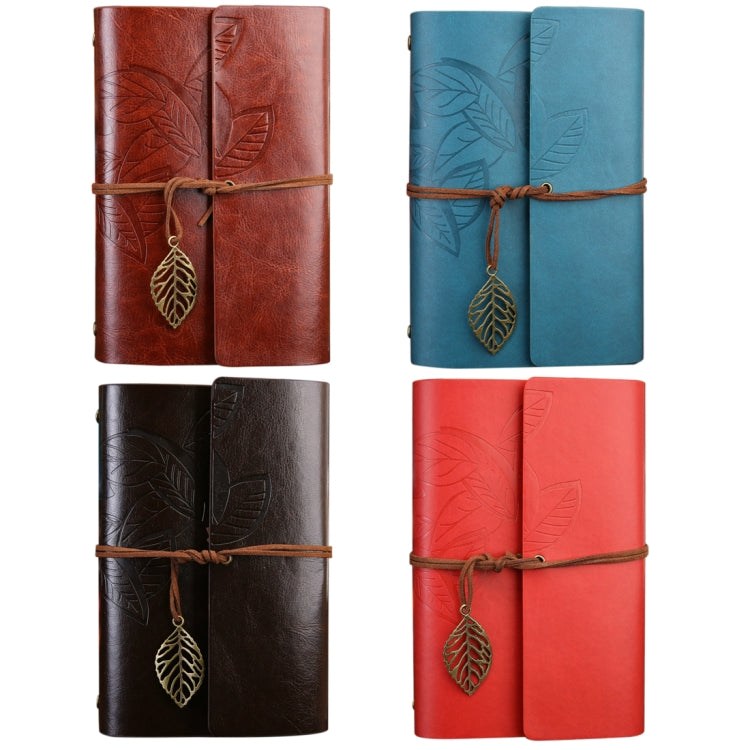 Assorted colors of loose-leaf travel diary notebooks with embossed leaf covers and leather strap charms