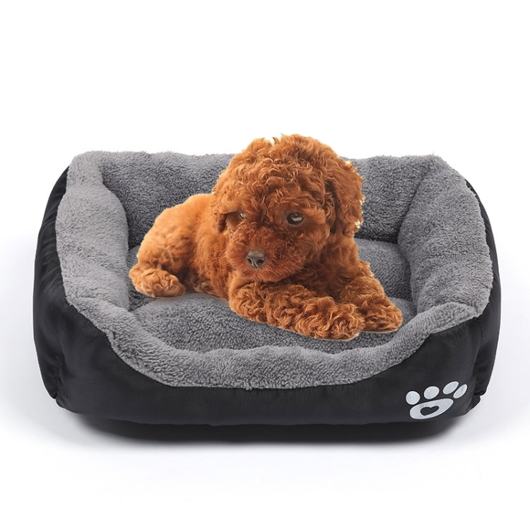 Gray and black teddy-style pet kennel mat with raised paw patch; dog lying inside