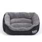 Gray plush and black pet kennel mat with paw-print emblem on the side
