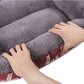 Gray plush interior with hands lifting the mat edge, revealing red outer fabric