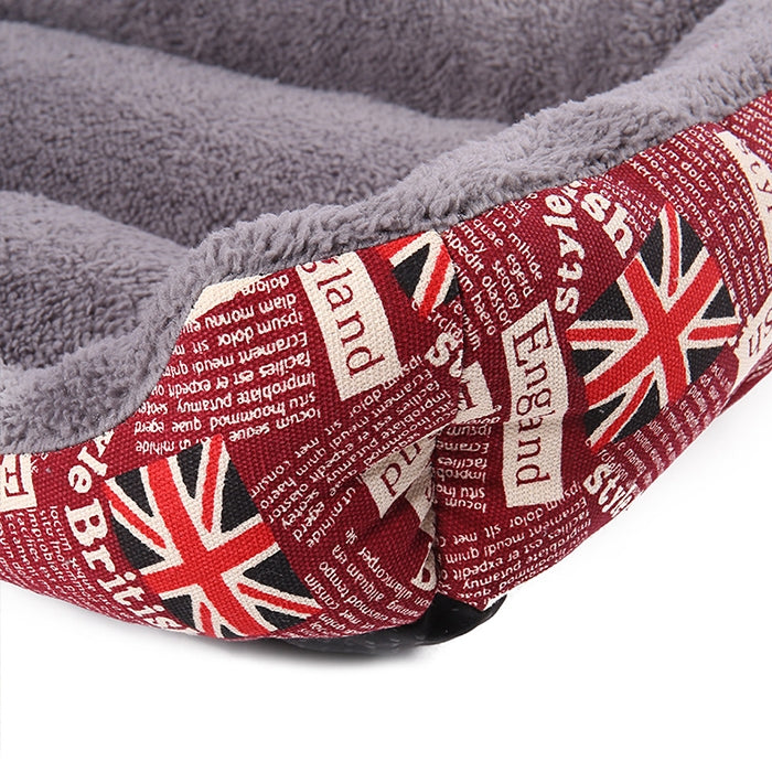 Corner of red outer pet mat with Union Jack print and gray plush padding