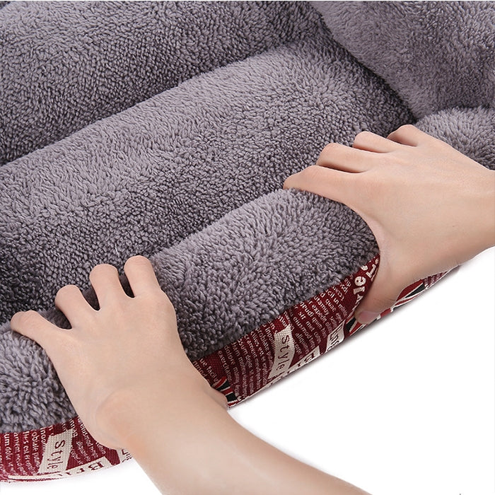 Gray plush dog kennel mat interior with hands showing cushioning and red patterned side
