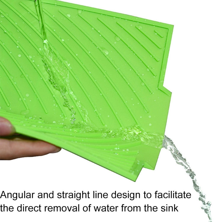 Green silicone water filter mat with angled drain ridges and water stream