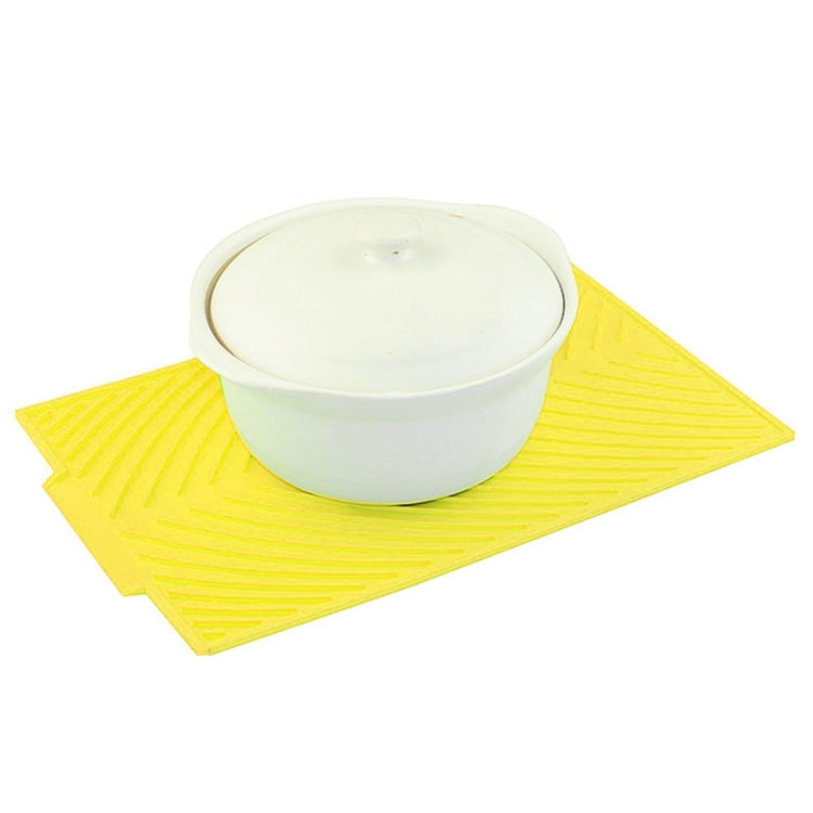 Yellow silicone foldable drain mat with small white cup on top
